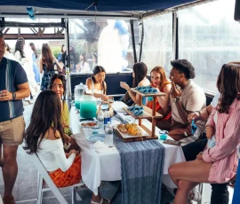 Group enjoying food and drinks inside a private charter boat during a Chicago boat rental.