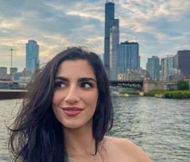 Portrait on the water with the Chicago skyline and Willis Tower in the background.
